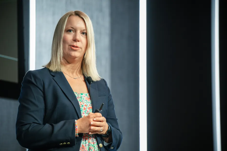 A woman presenting on a stage.