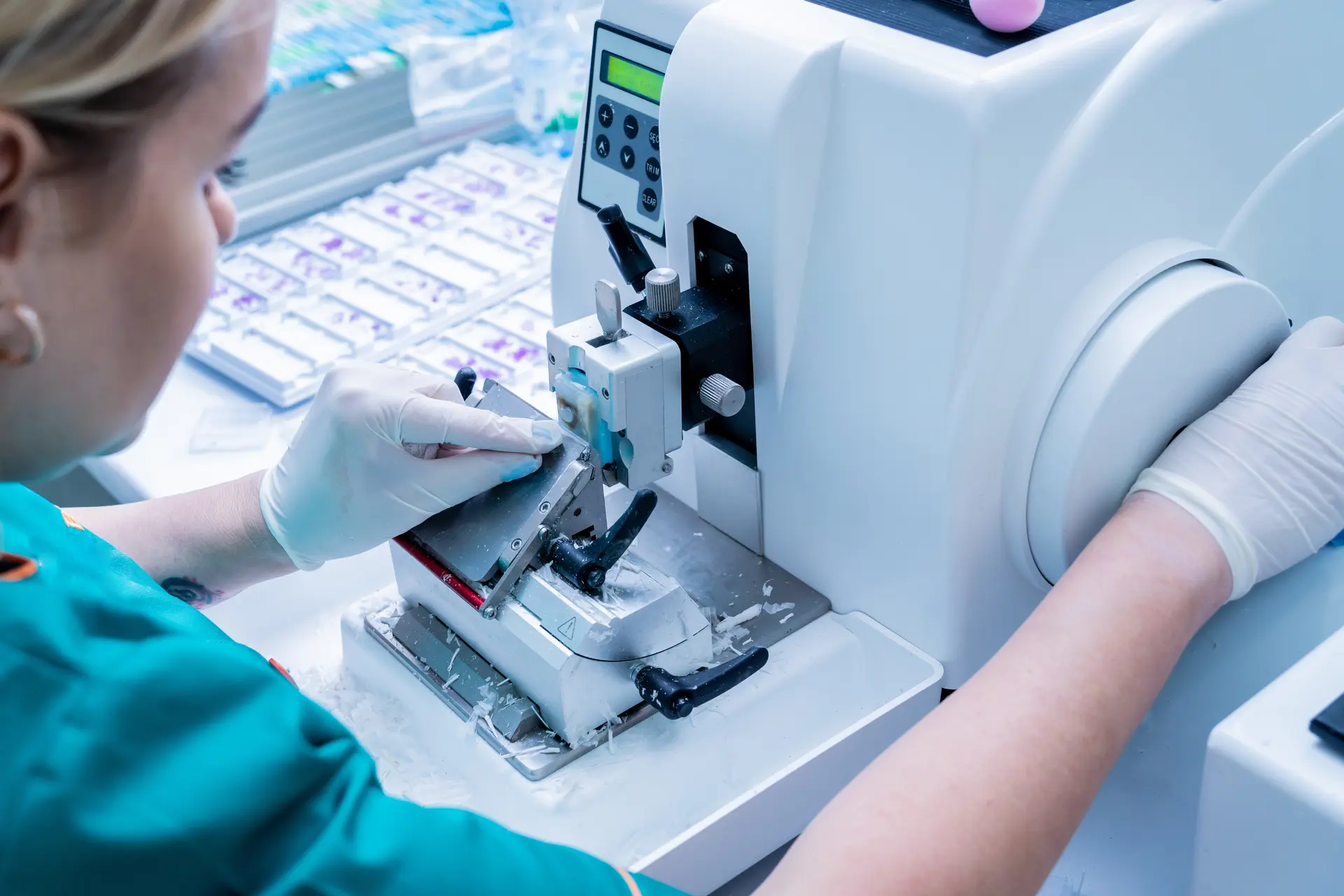 woman working operating a microtome in the lab