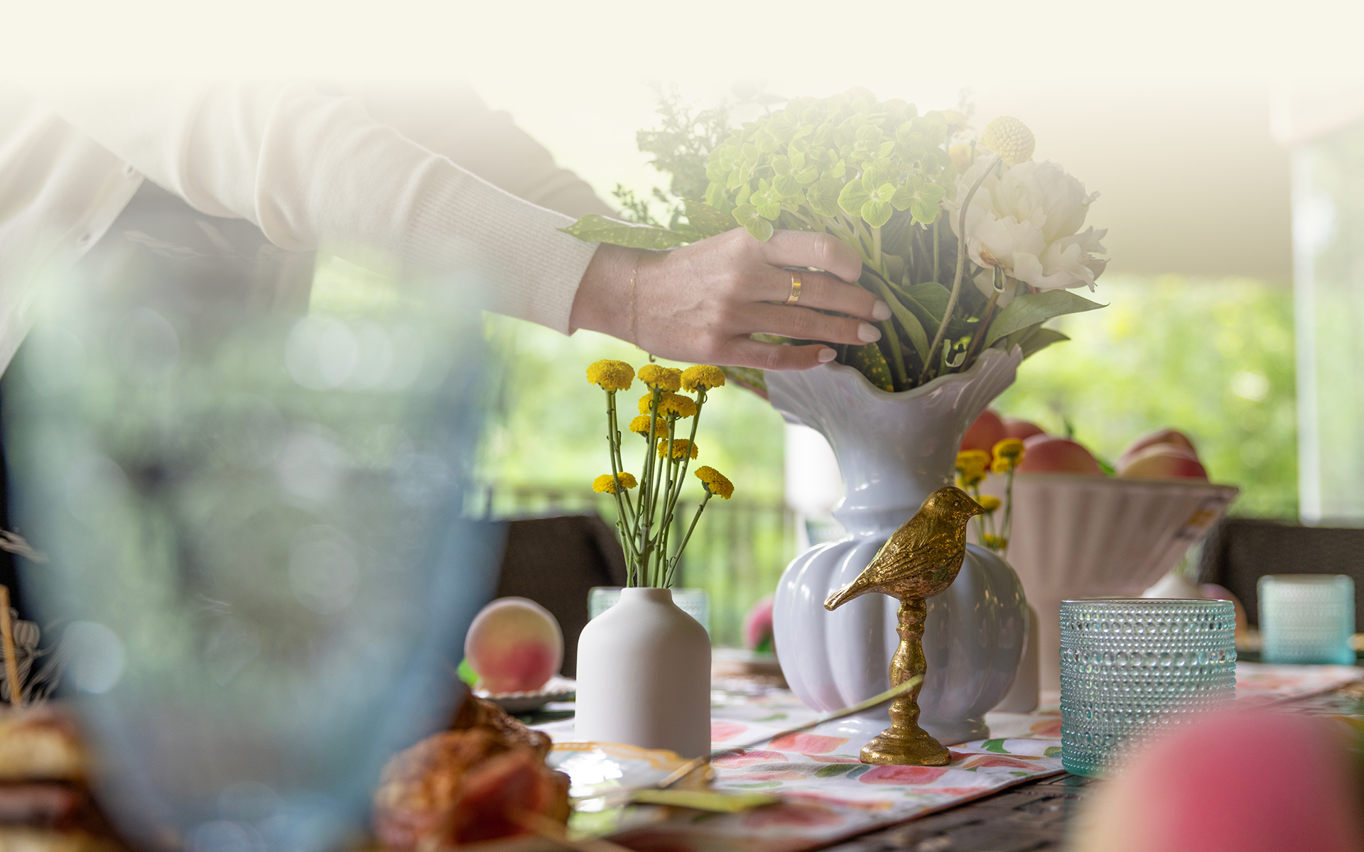 A Goldfinch team member fixing a flower centerpiece. 
