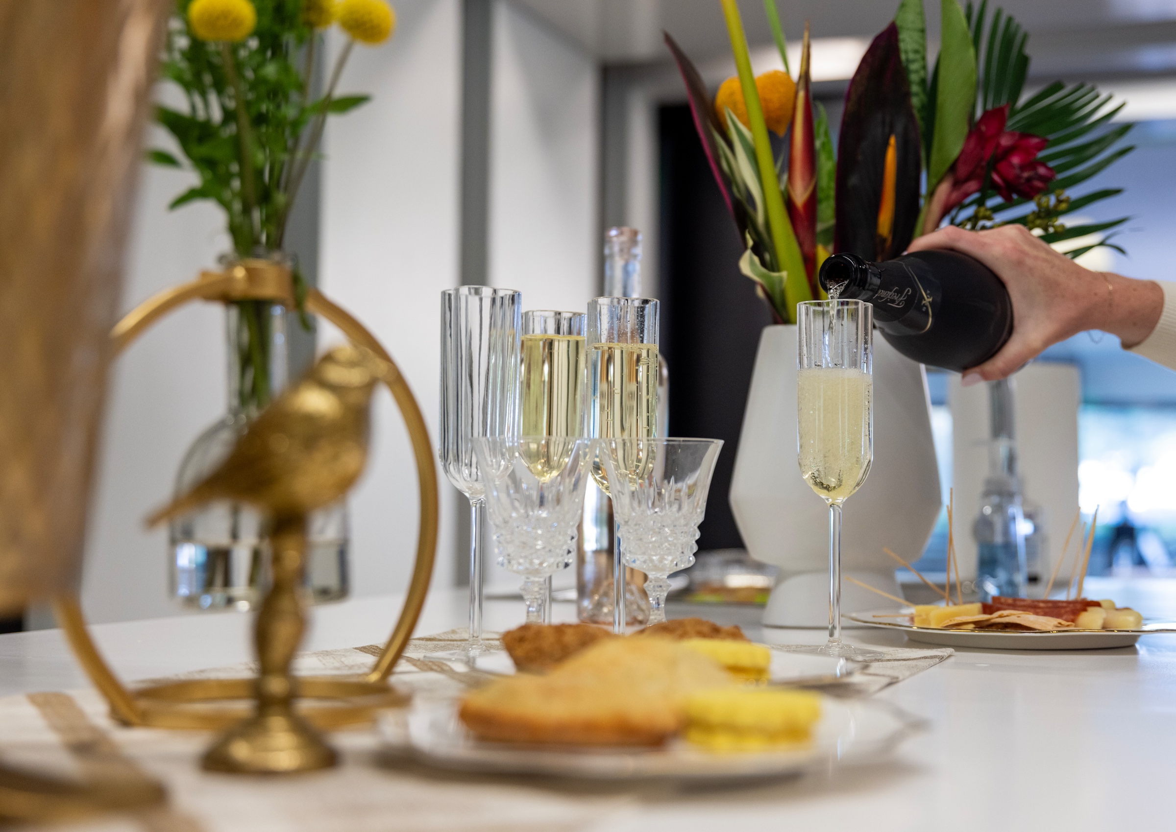 A tablescape with champagne being poured in a glass.