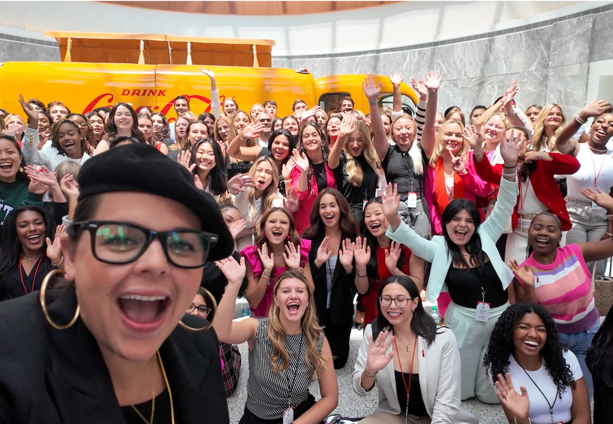 A group photo of women at a Coca-Cola event.