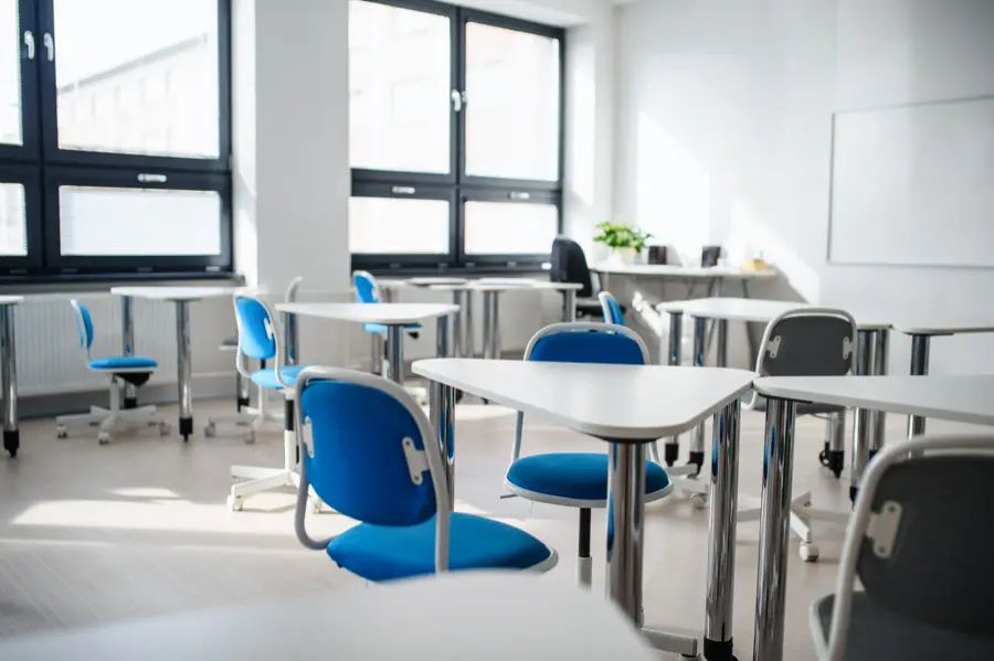 Photo of a sparkling clean classroom with desks and chairs