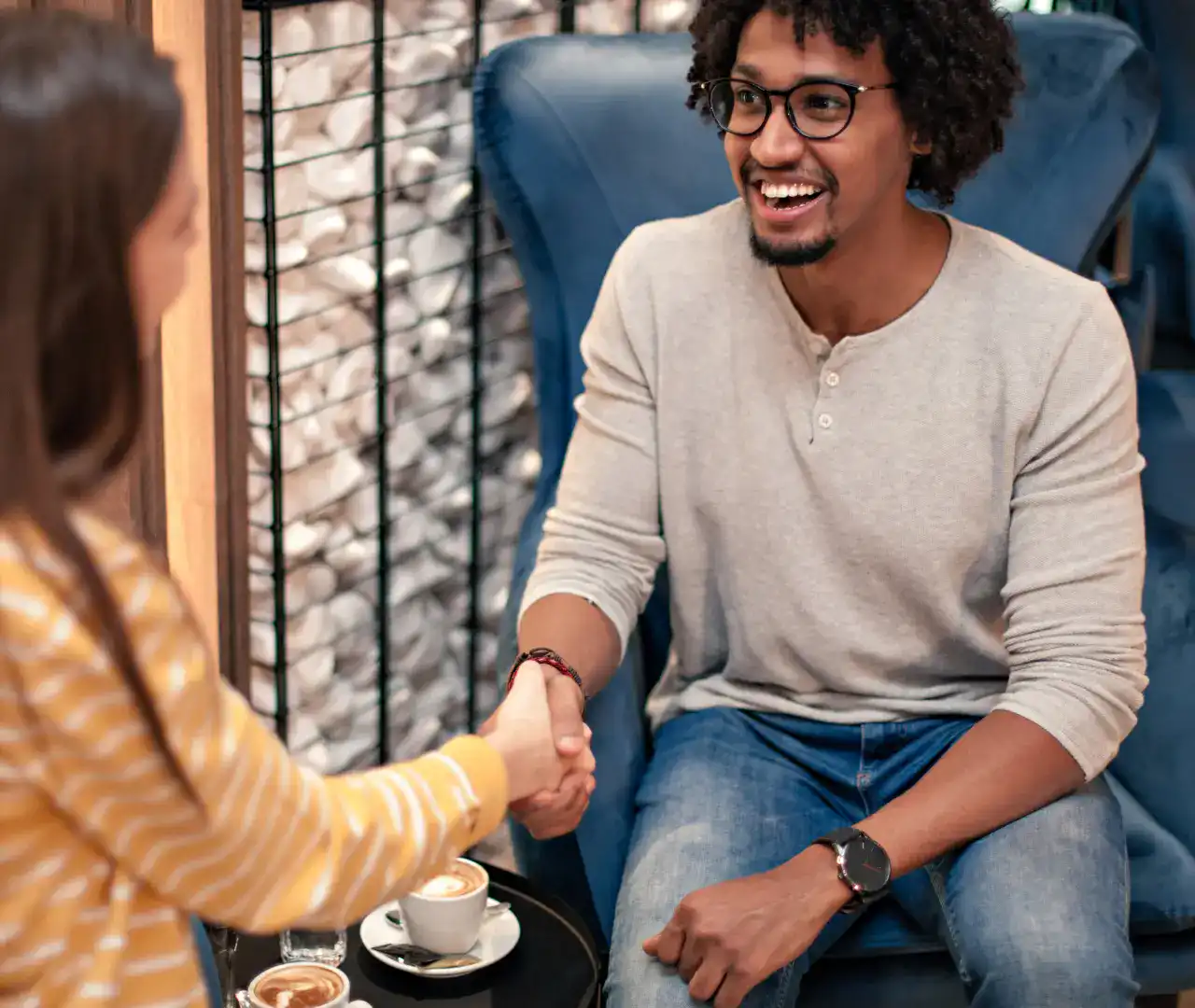 Young smiling professionals shaking hands