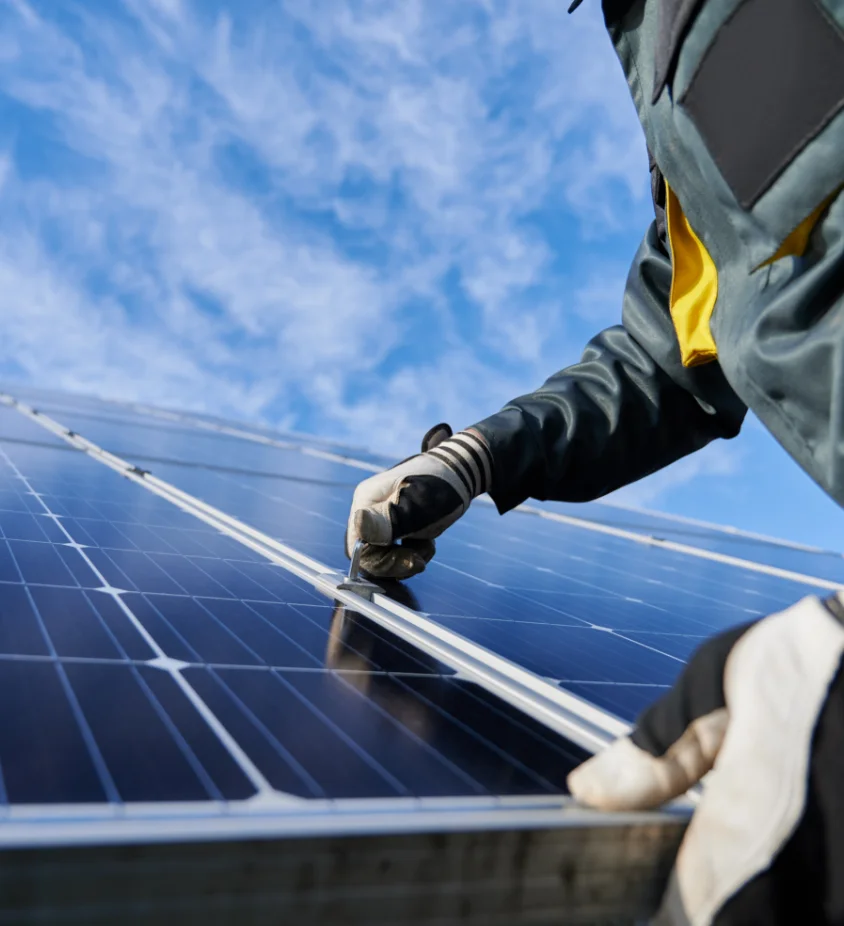 Technician installing a solar panel on a commercial solar project in Indiana