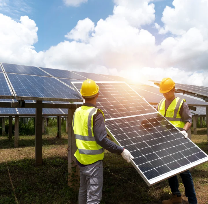 Solar technicians installing photovoltaic panels on a commercial project site in Indiana