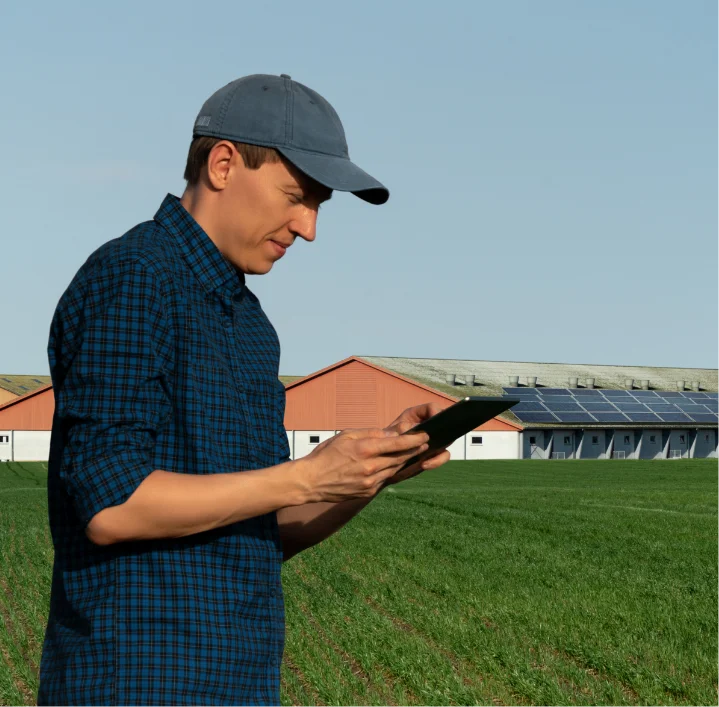 Indiana farmer using a smartphone to monitor solar energy system performance in the field