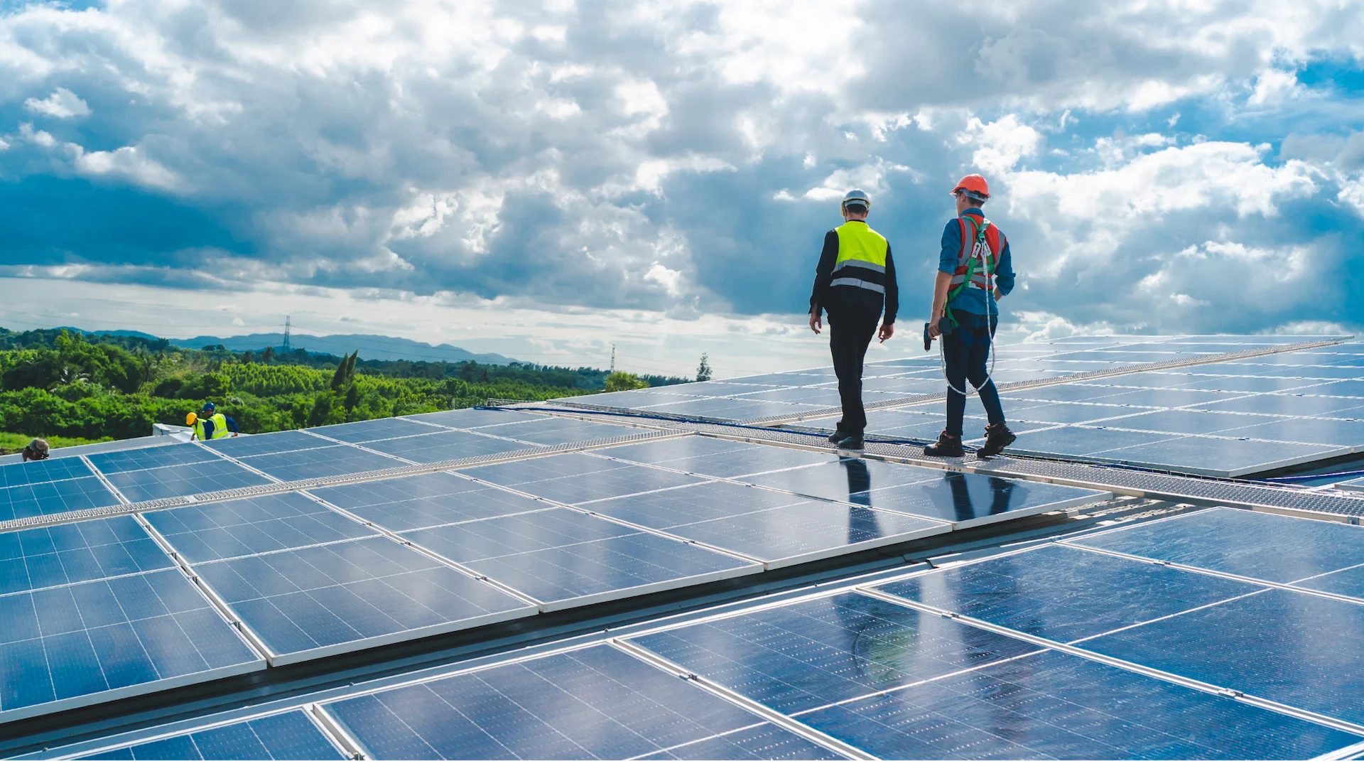Commercial solar representatives walking on installed panels with a scenic agricultural landscape in Indiana