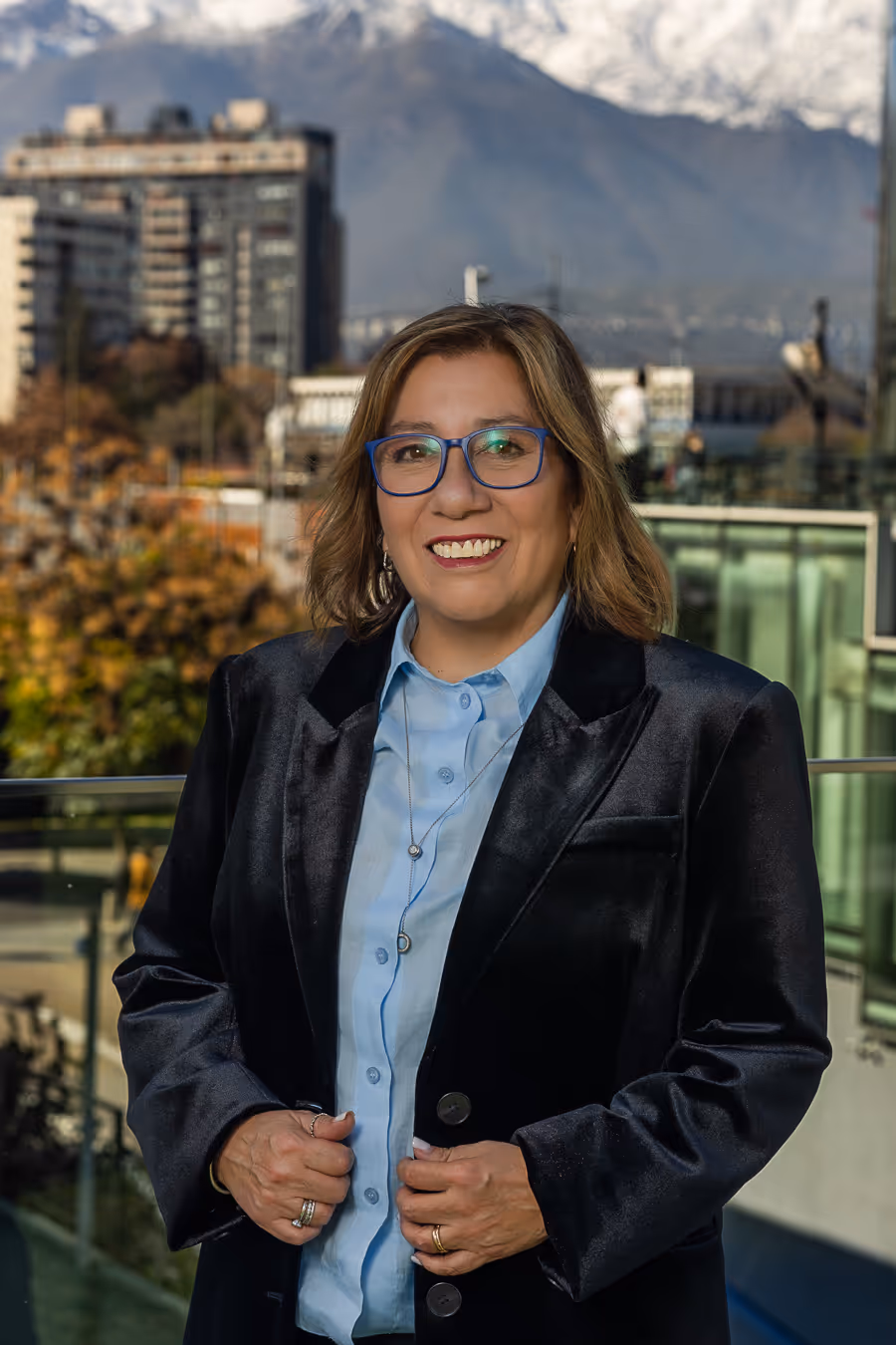 Retrato de Silvia Sepúlveda con fondo de ciudad y montañas