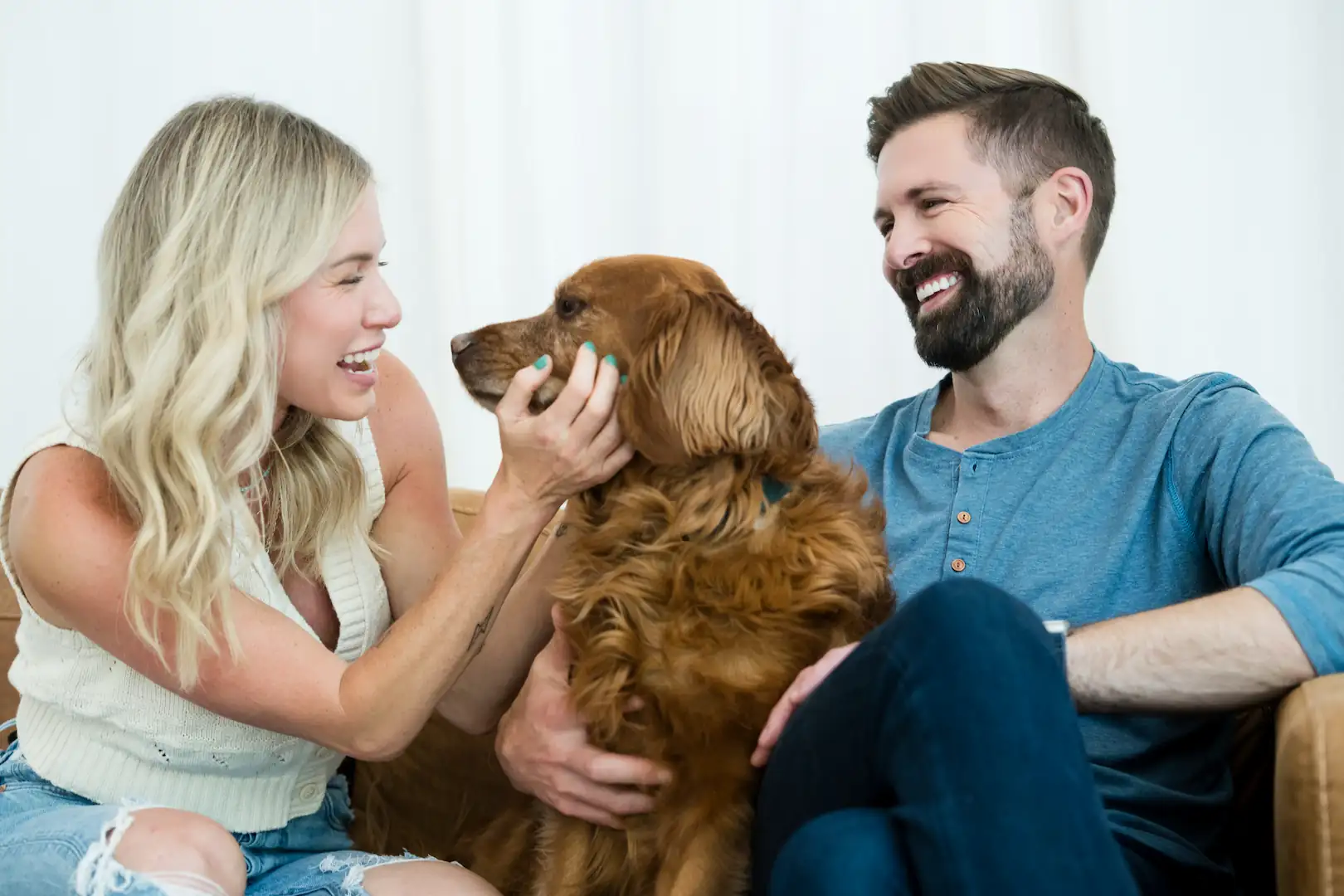 Smiling Espire patients sitting together with their dog, sharing a joyful moment and showing bright, healthy smiles.