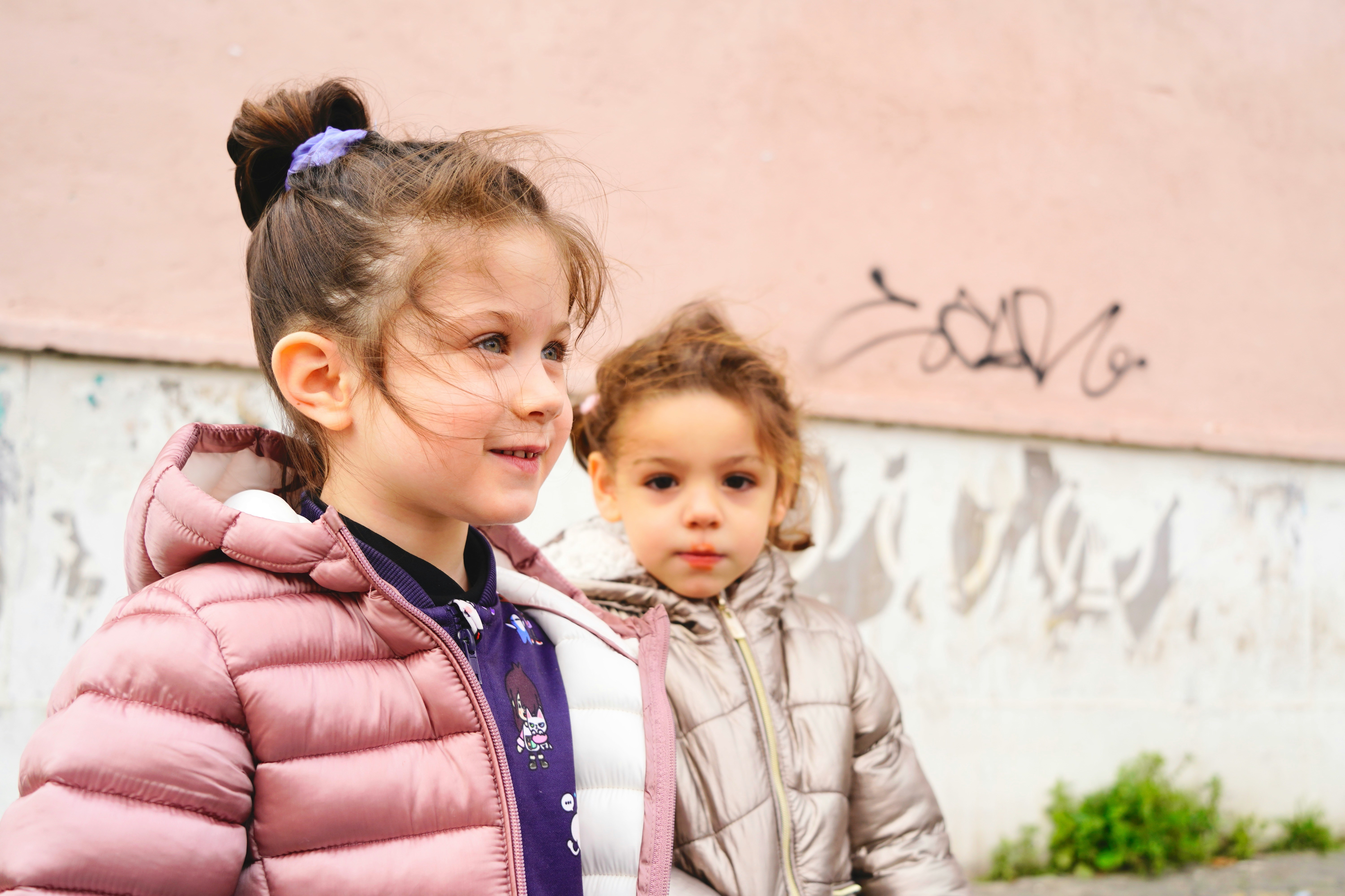 2 girls with winter coats on 