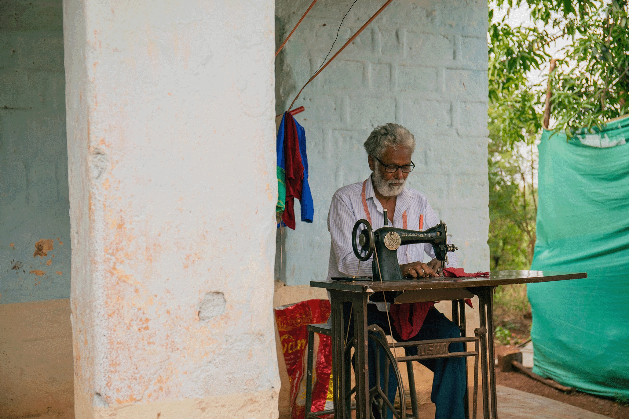 man working on sowing machine