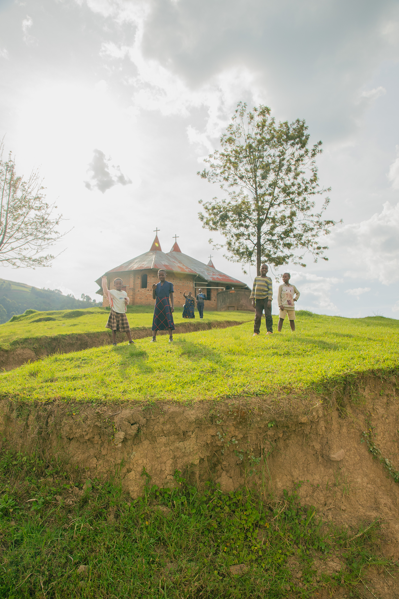 church on a hill behind some kids