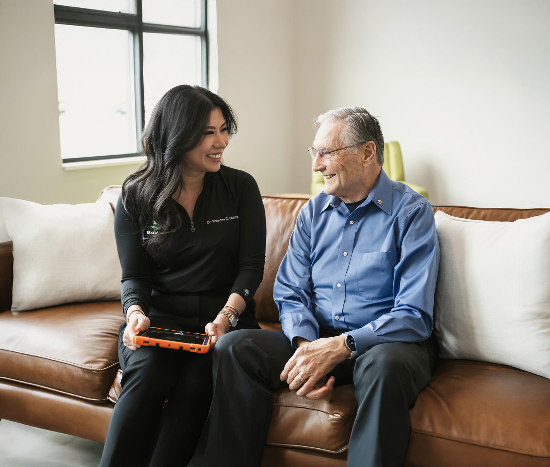 Dentist talking to senior patient