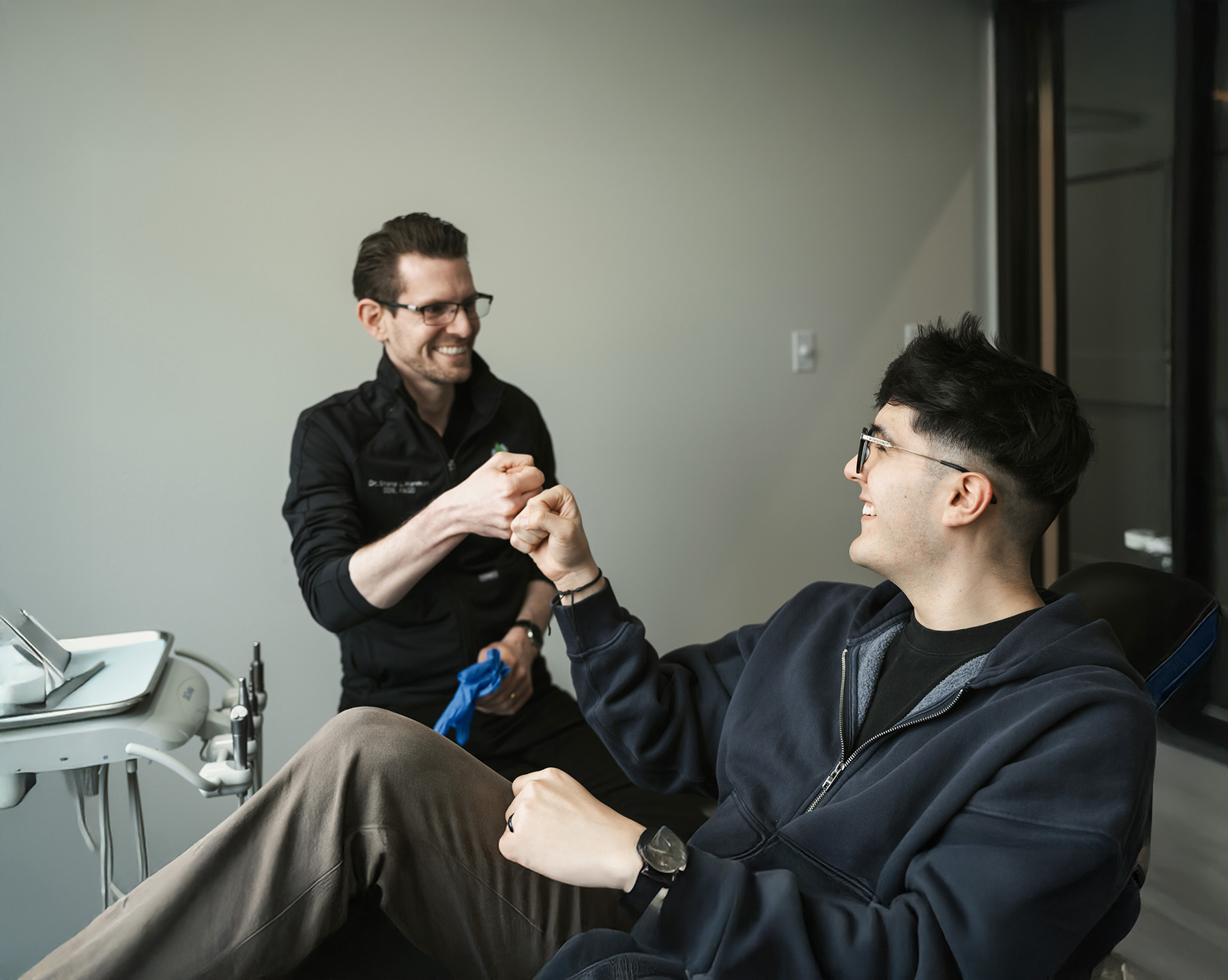 Dentist giving fist bump to patient