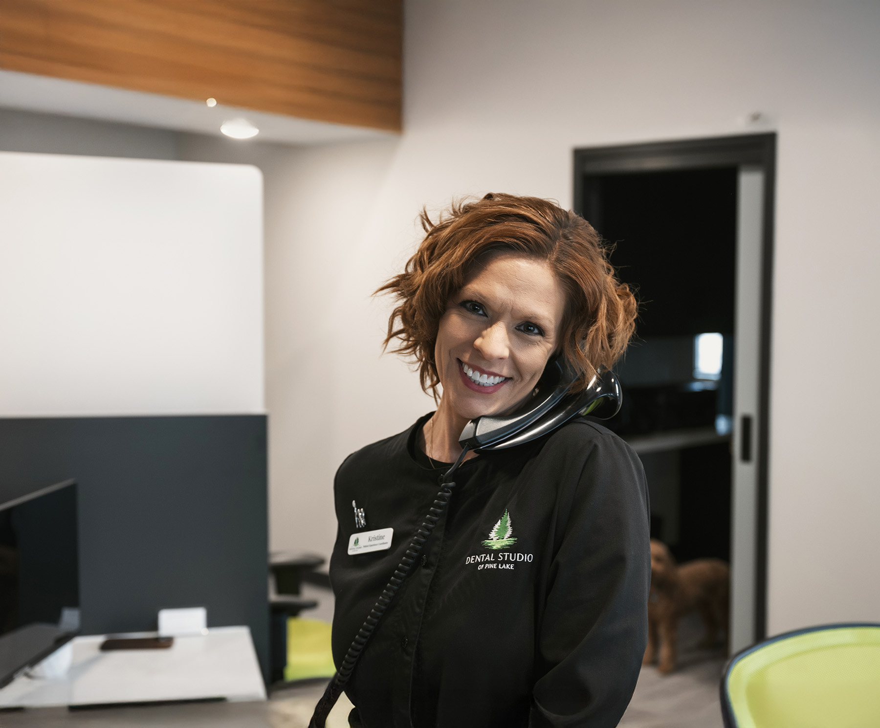 Receptionist smiling while answering the phone