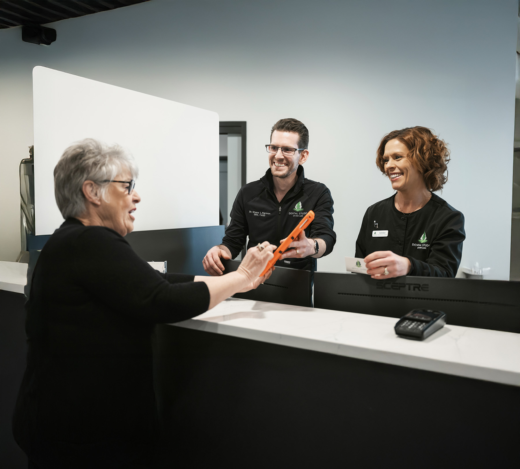 Dentists smiling while looking at tablet