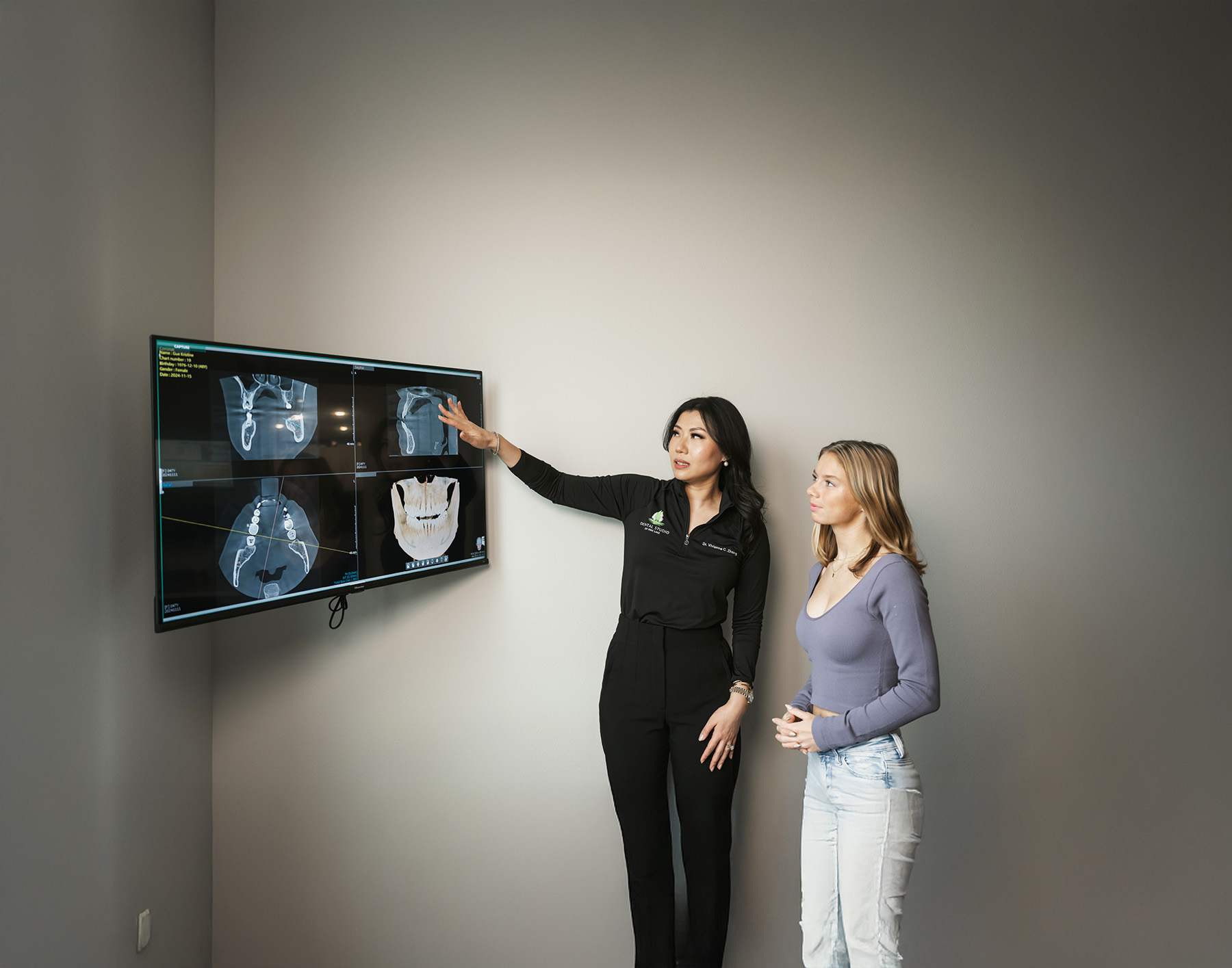 Dentist showing patient dental x-ray