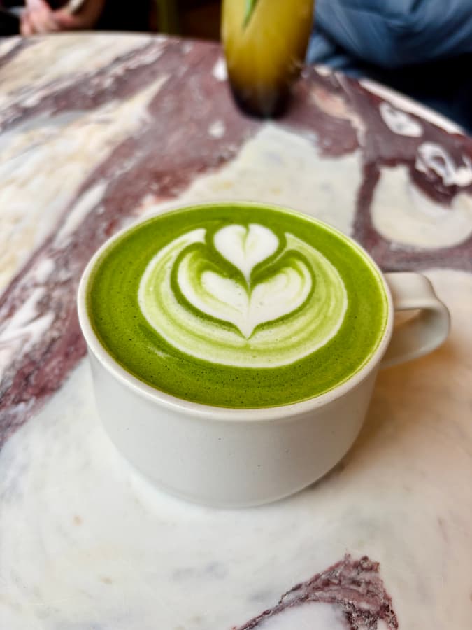Hot matcha latte with decorative foam