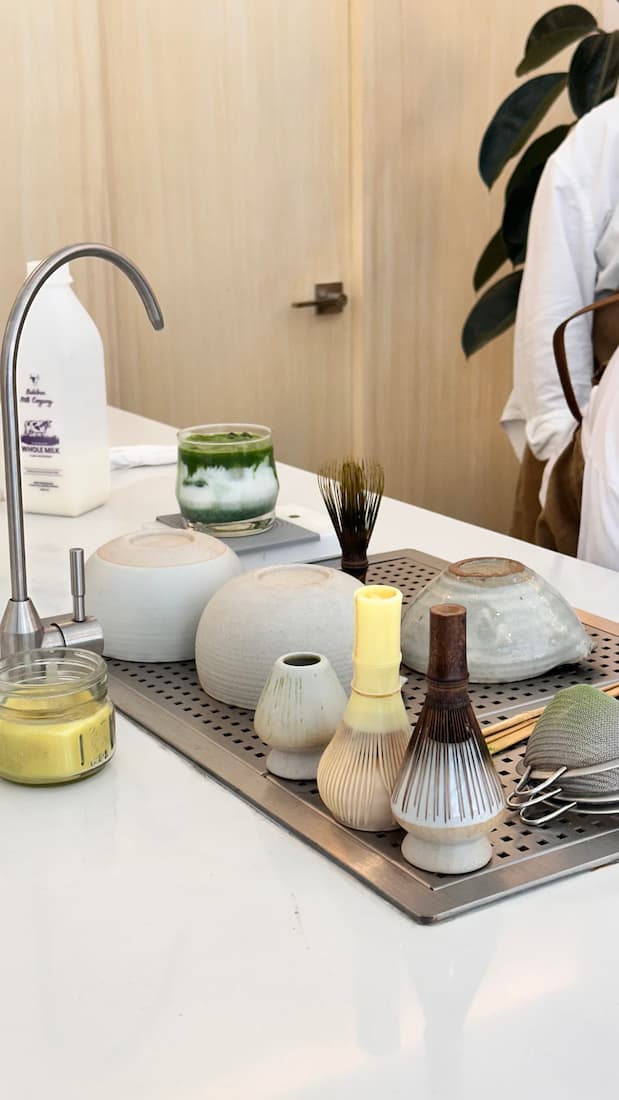 Matcha dishware lined up on a counter ready to prepare matcha drinks
