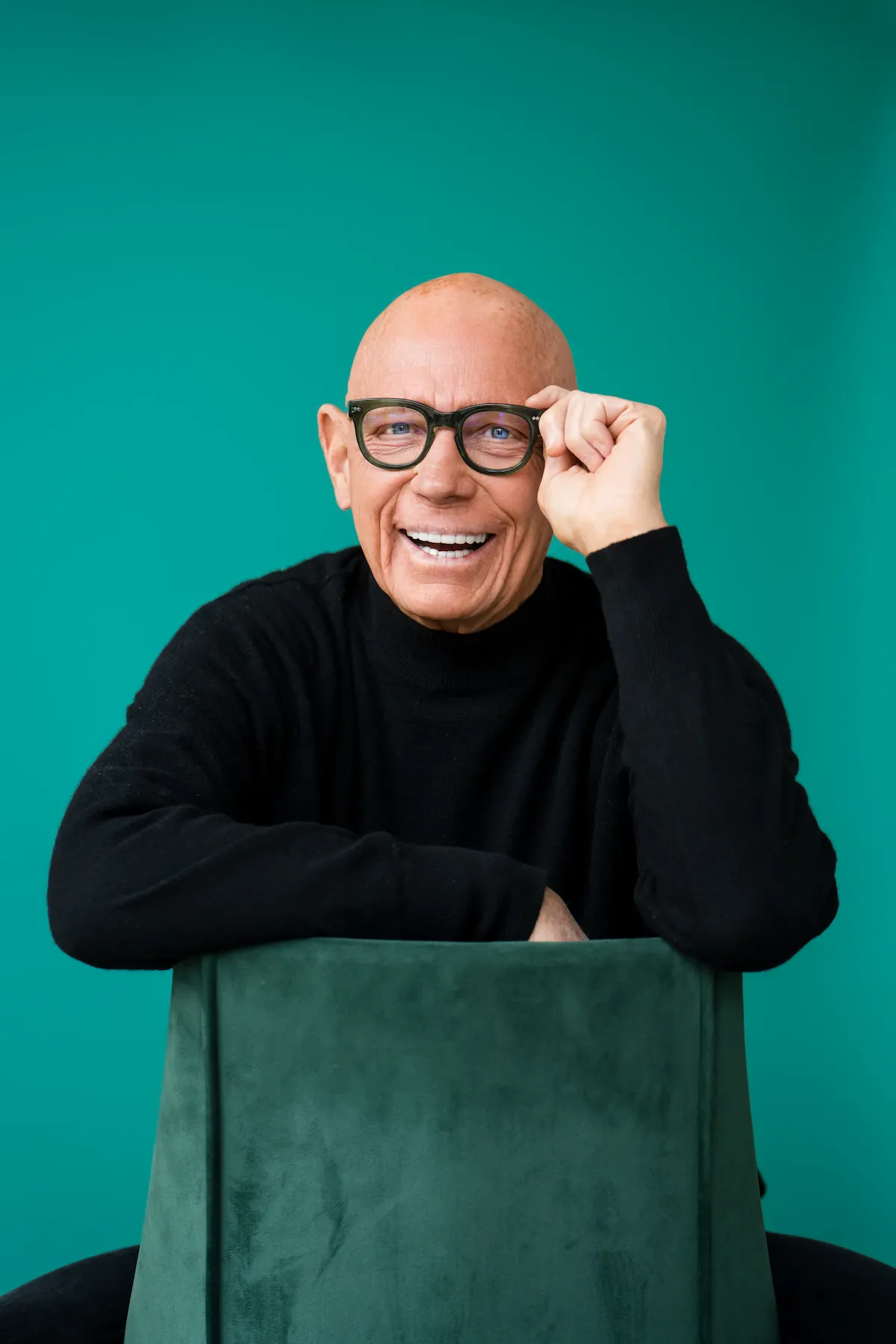 Smiling older man wearing glasses and a black sweater showing his bright, confident smile after dental care at Espire Dental.