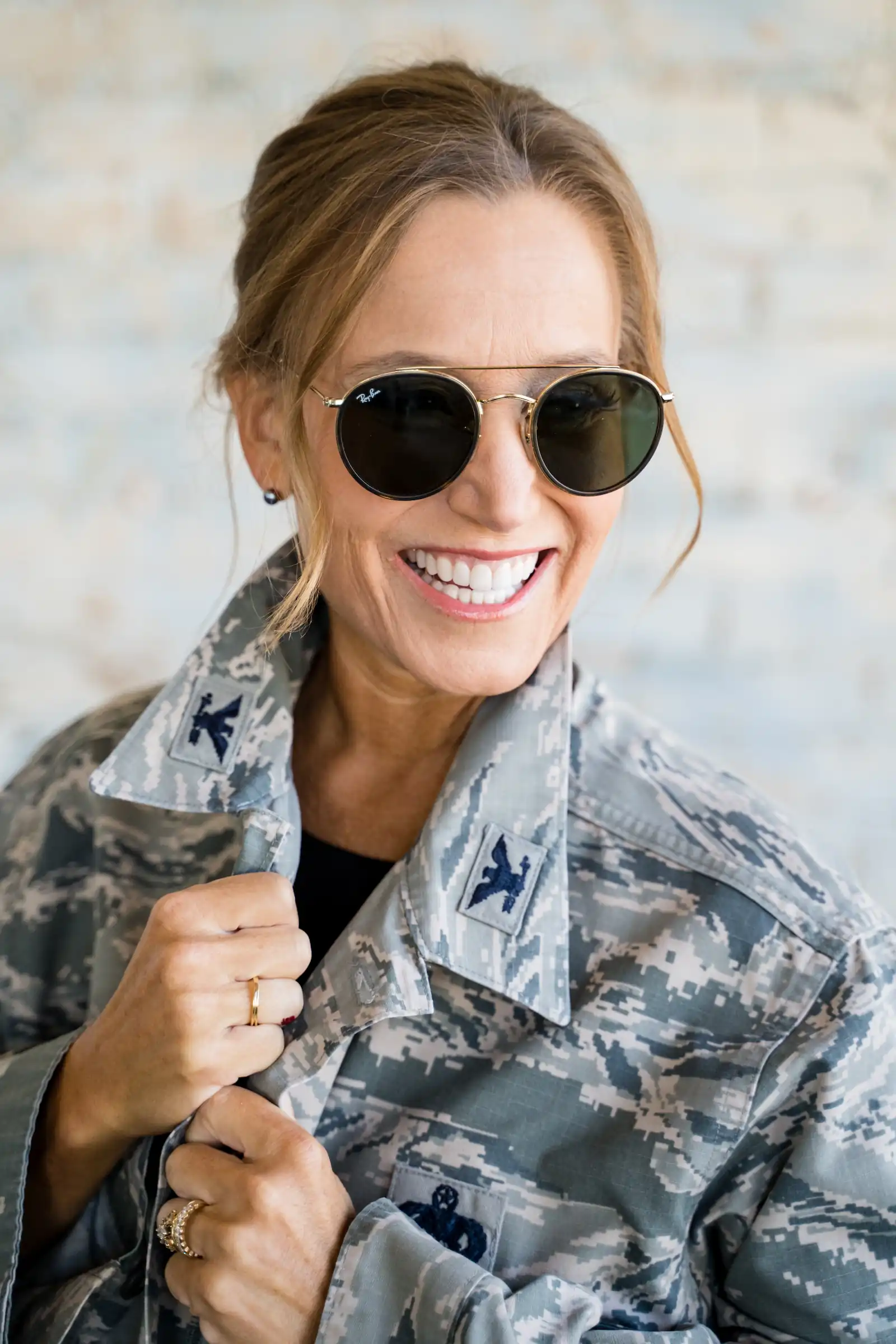 Smiling woman in an Air Force uniform, showing confidence and a bright, healthy smile.