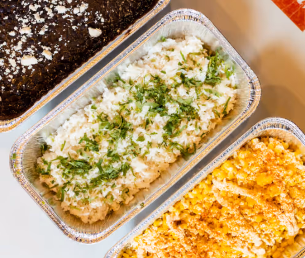 Trays of enchiladas and elote at Taqueria La Ventana