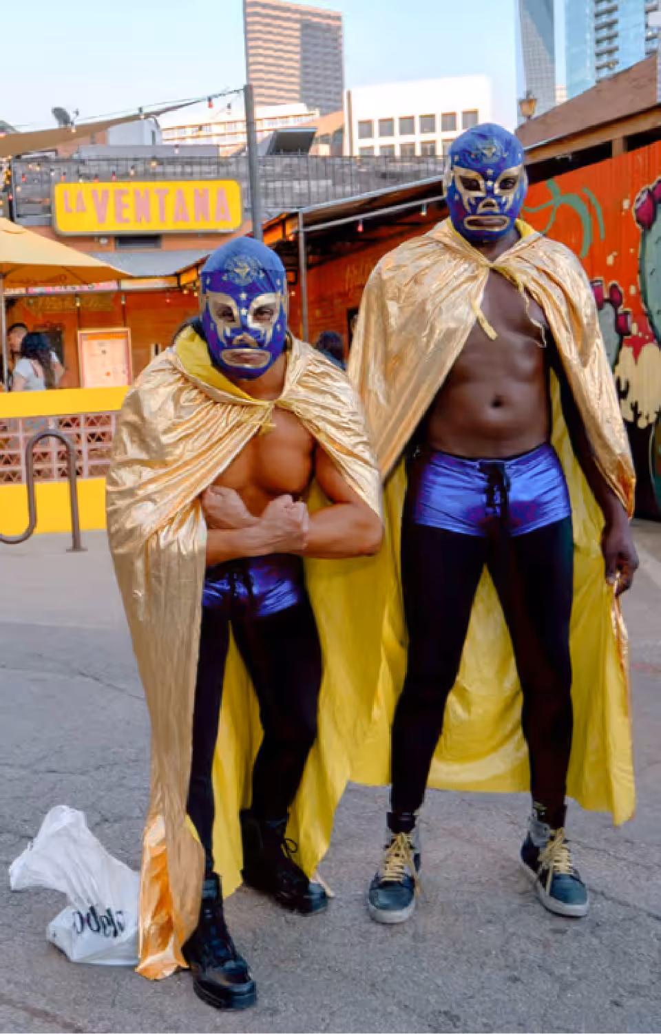 Guests posing in lucha libre costumes