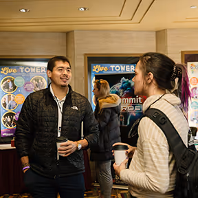 Two professionals networking at the Summit