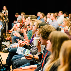 Audience clapping at the annual Summit
