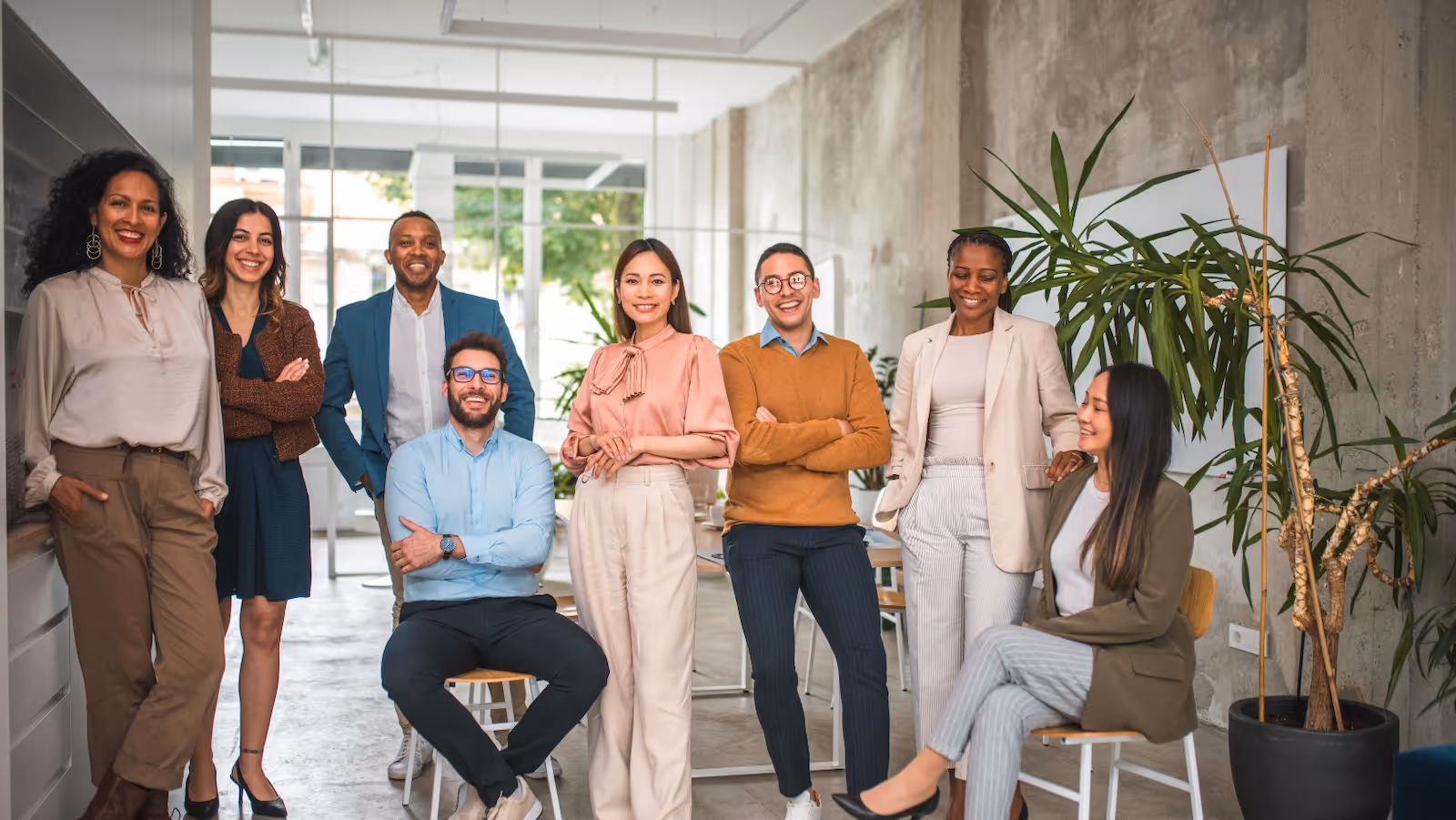 A group of people standing and sitting in a room.