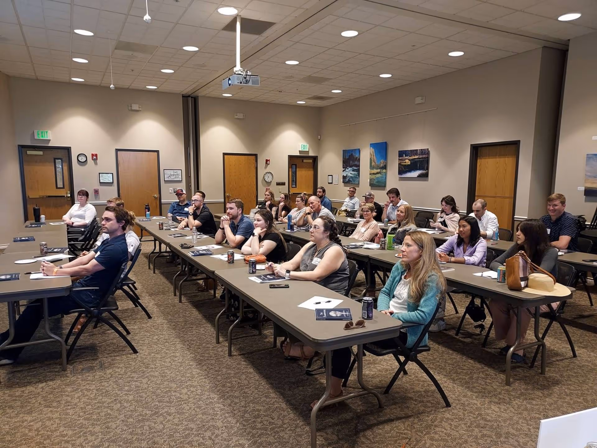 A group of people sitting at tables in a room.