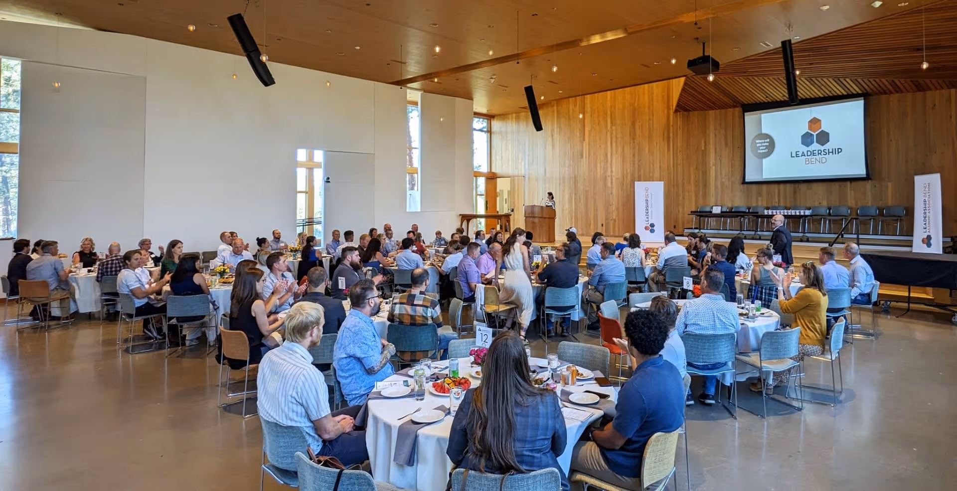 A group of people sitting at tables in a room.