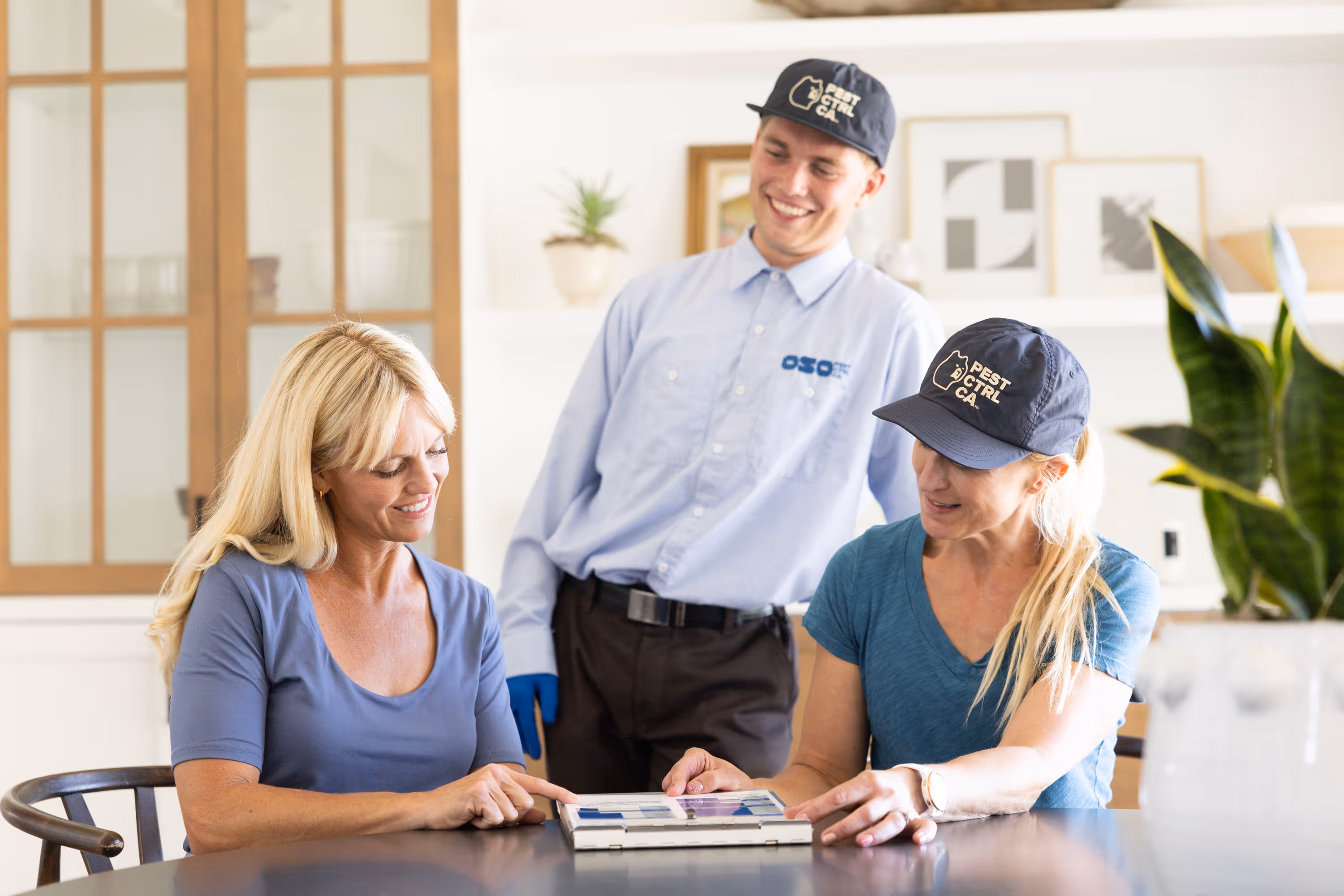 Oso Pest Control expert walking a customer through their pest control services.