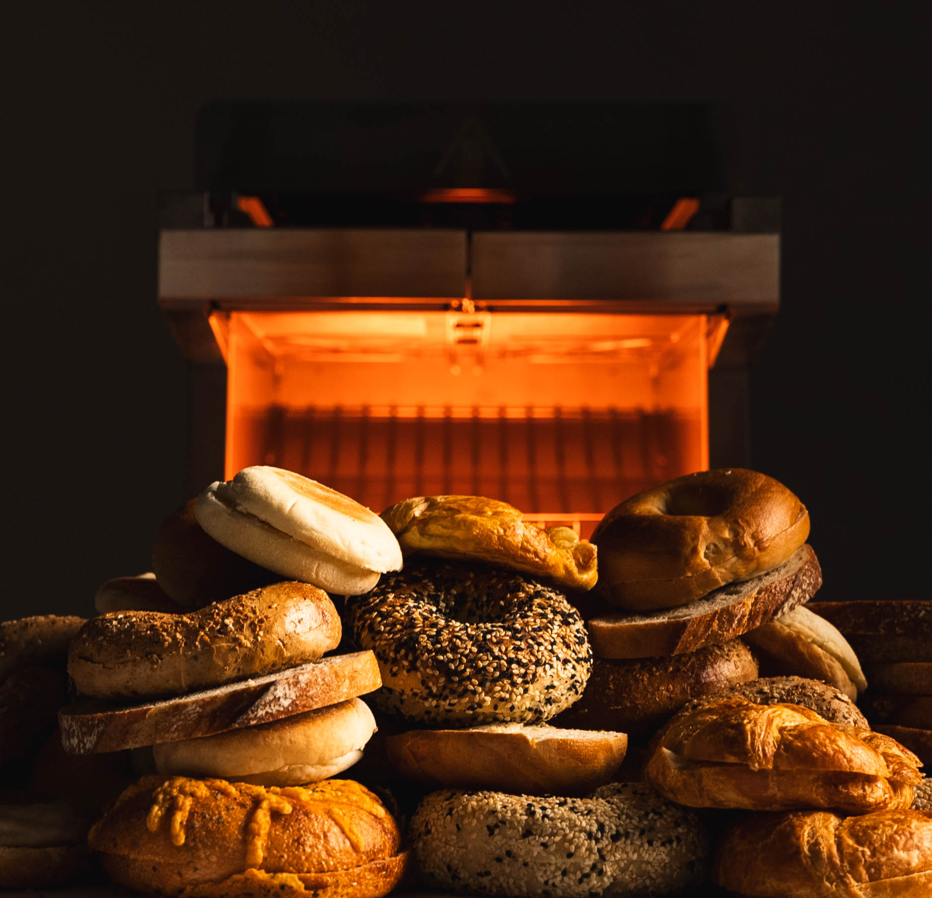 toast ez behind a stack of breads