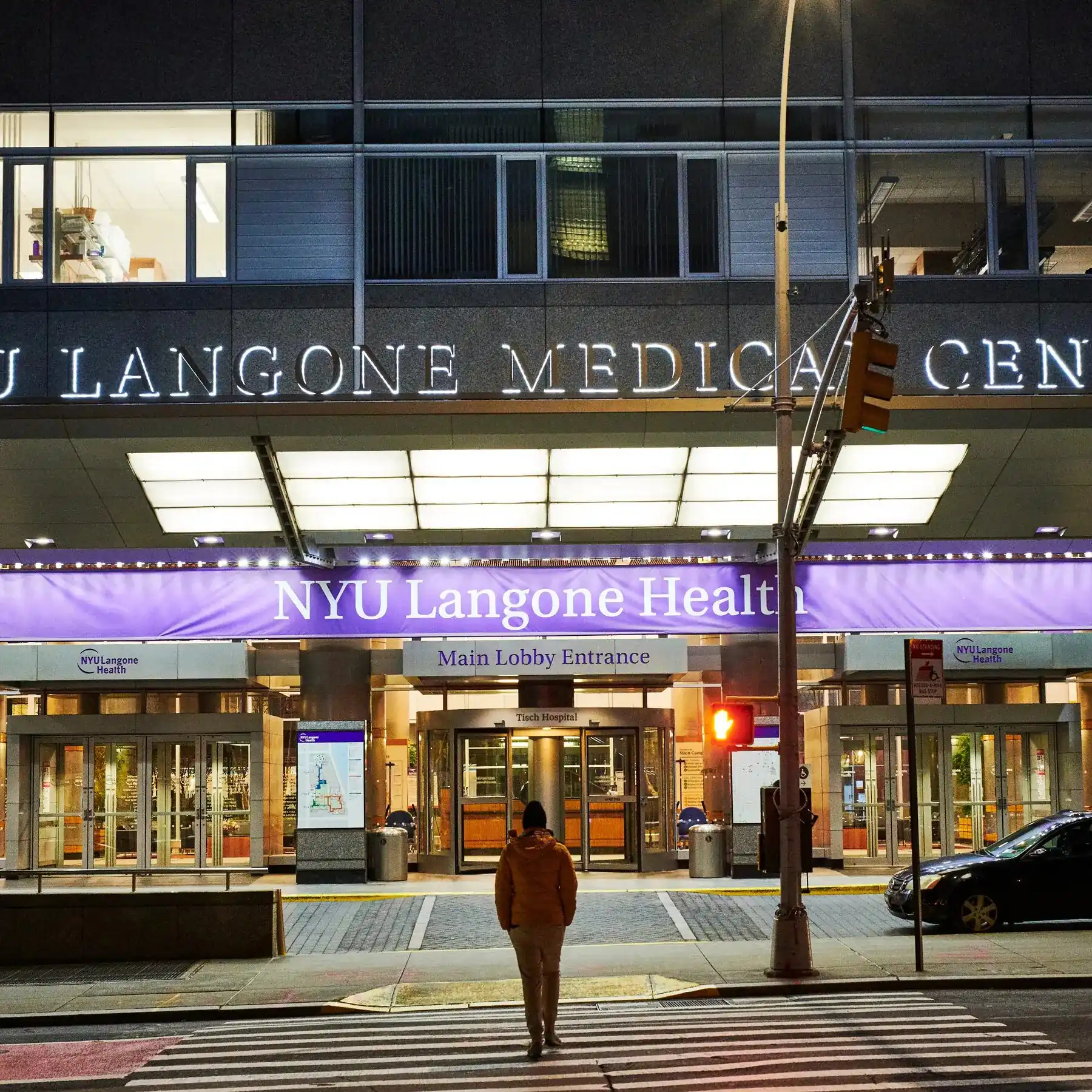 person standing in front of hospital entrance