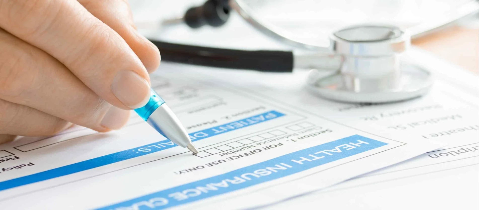 closeup pen writing on hospital bills and documents