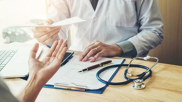 doctor and patient discussing at desk