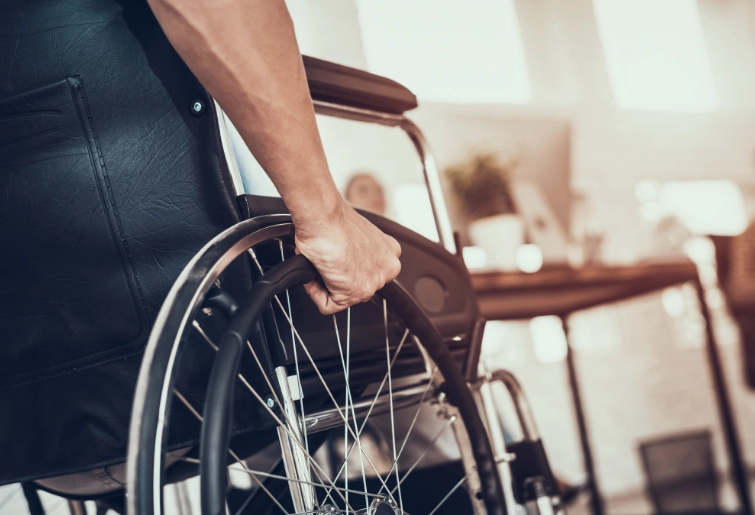 hands pushing wheelchair close up