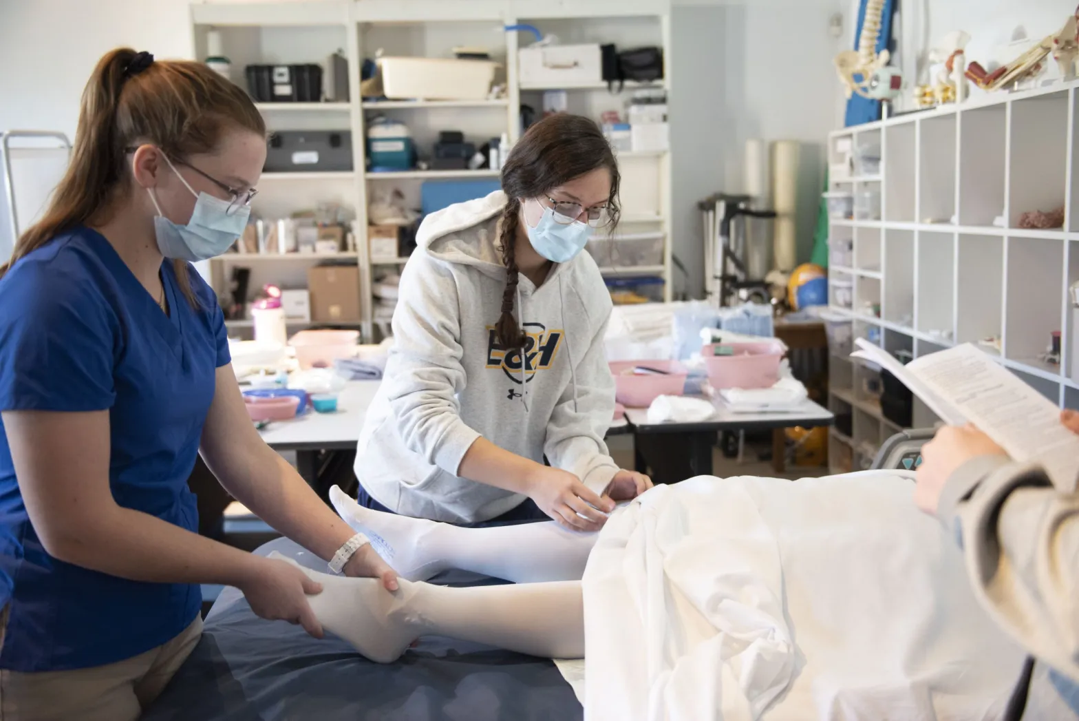 Future nursing students at the Emory & Henry School of Nursing campus in Marion practice leg compression techniques in a state of the art lab. A new lab school will provide training and exposure to health care careers to high school students. Courtesy of Emory & Henry College.