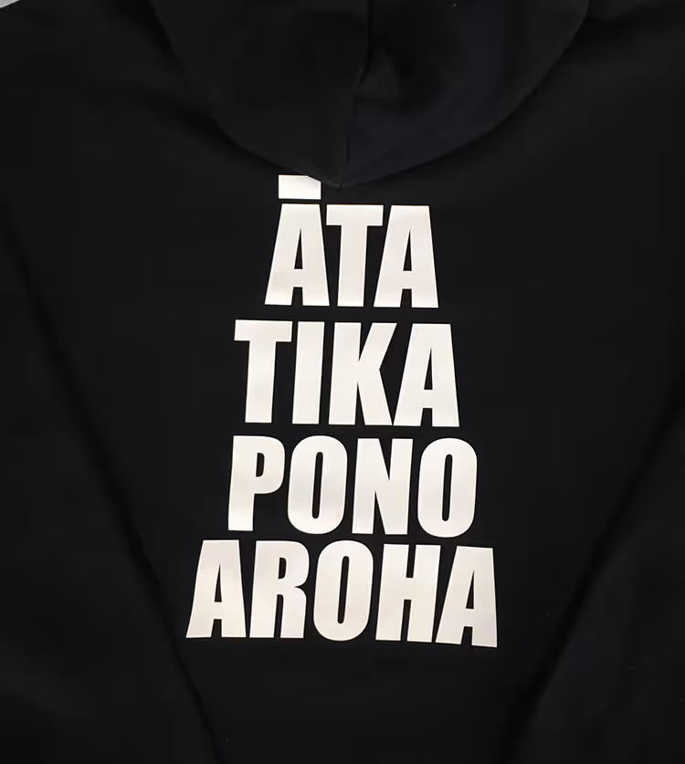 Screen printing white text onto the back of a black hoodie