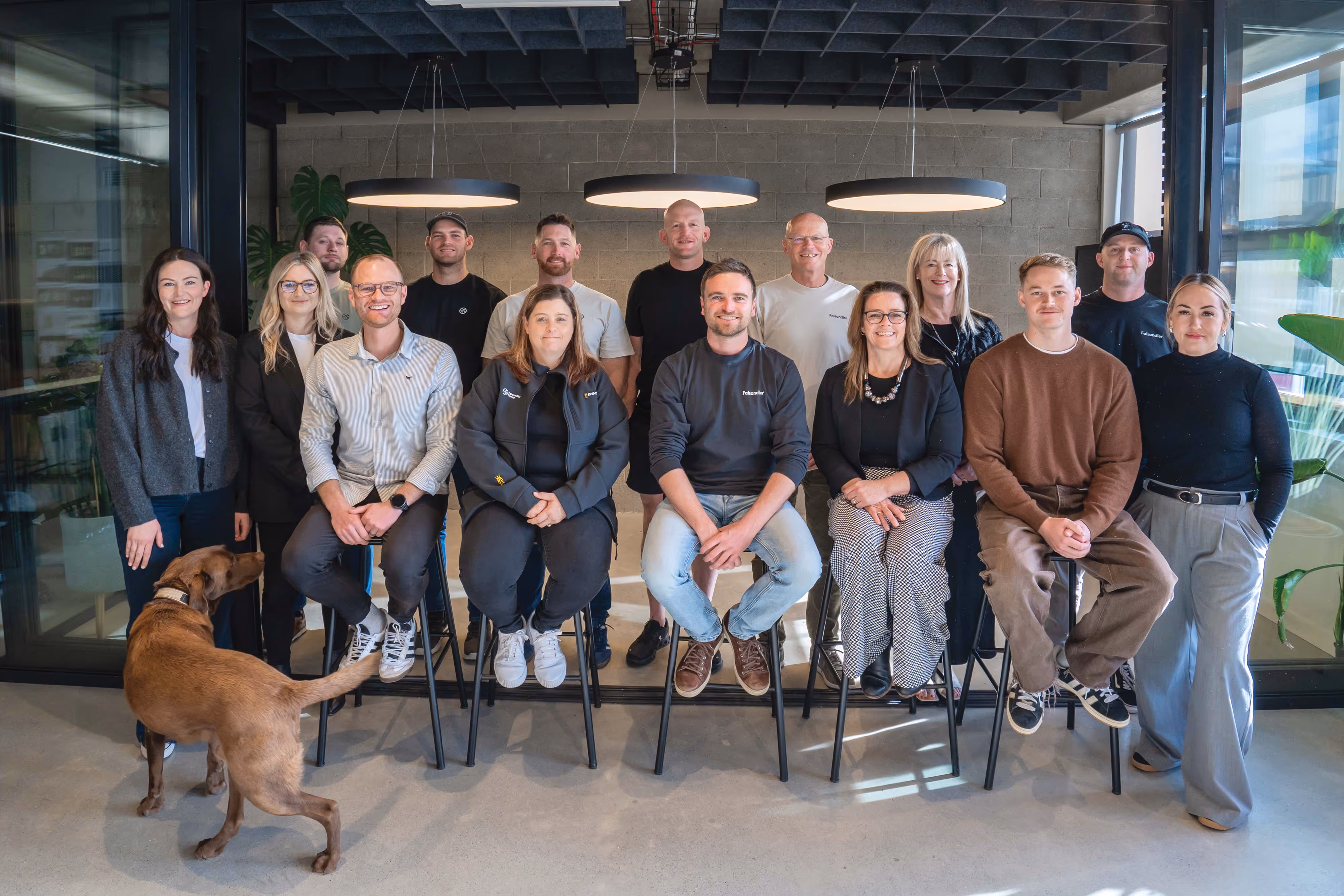 A group photo of the Faisandier team in our modern office space, complete with our beloved office dog. 