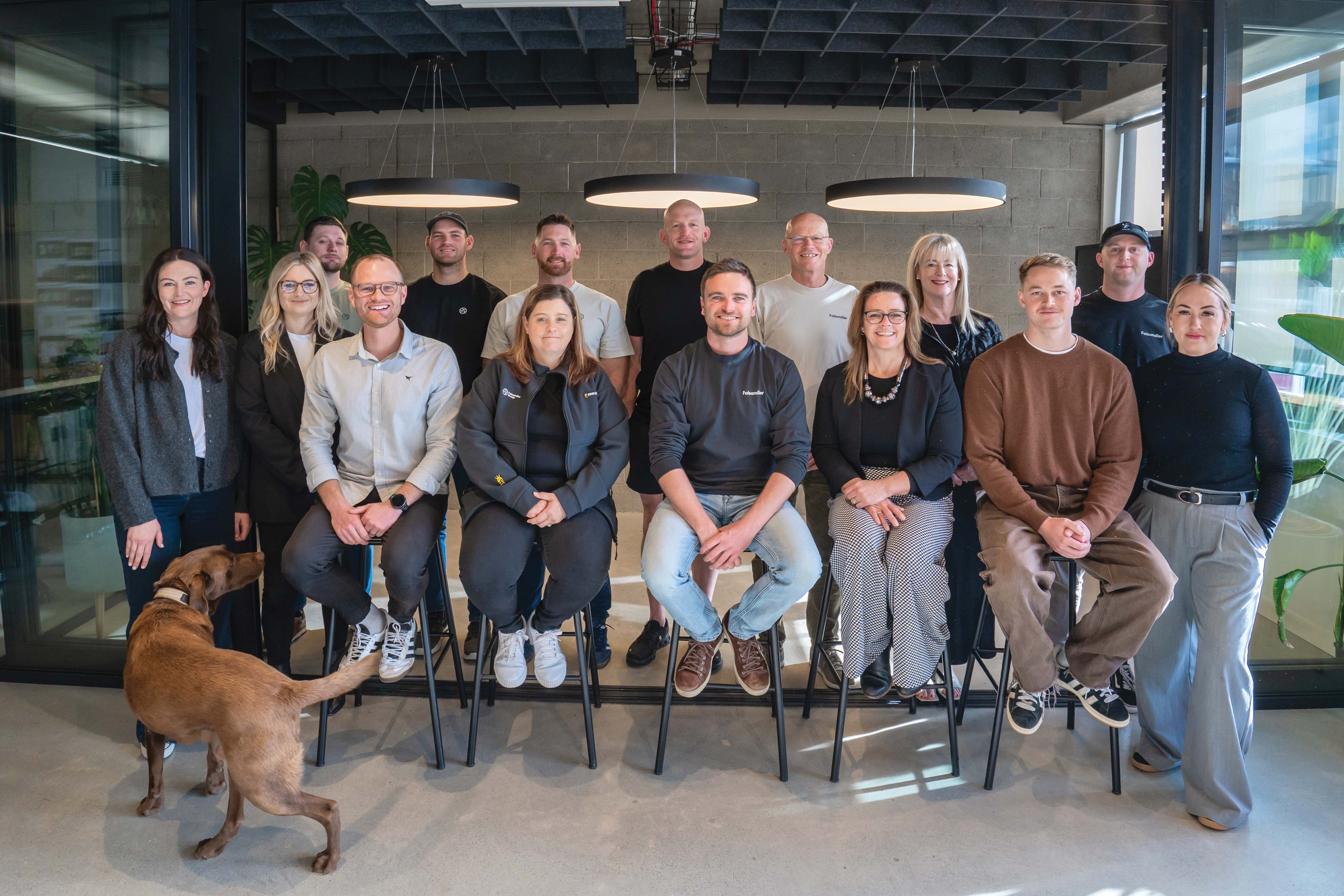A group photo of the Faisandier team in our modern office space, complete with our beloved office dog. 