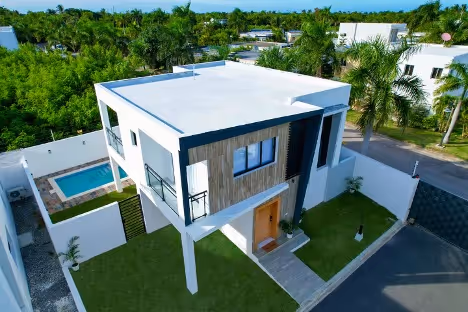 Bird's eye view of modern white home with pool
