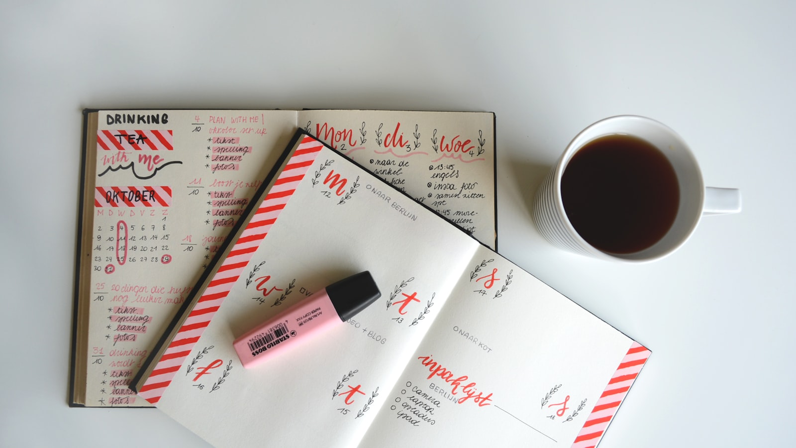 A monthly planner and calendar with coffee on a desk, illustrating a short-term rental operating cadence