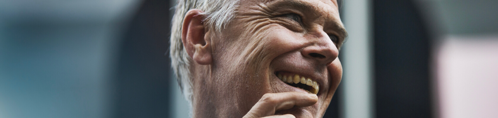 A closeup of a smiling man.