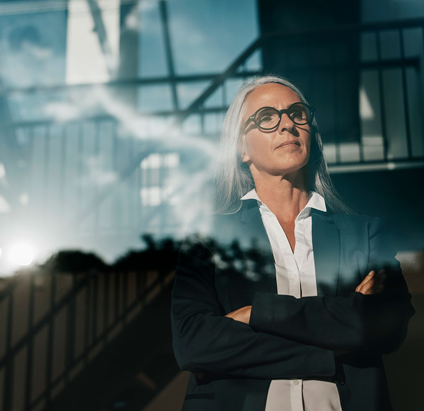 A confident woman looking out a window past the viewer.
