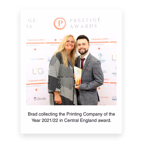 Brad receiving the Printing Company of the Year 2021/22 Central England award at the Prestige Awards, posing with his mother against the event backdrop.