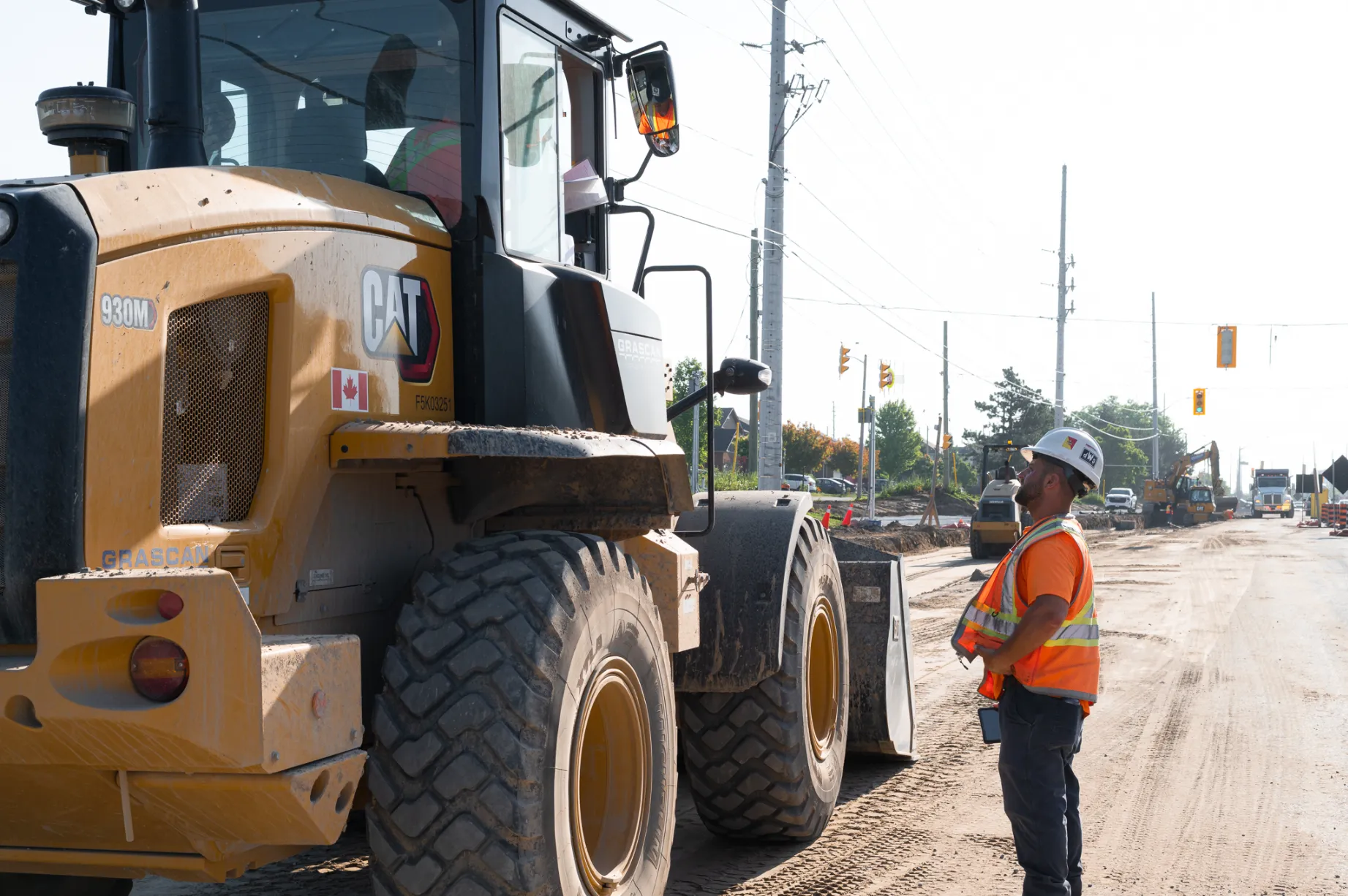 Man standing next to large construction vehicle