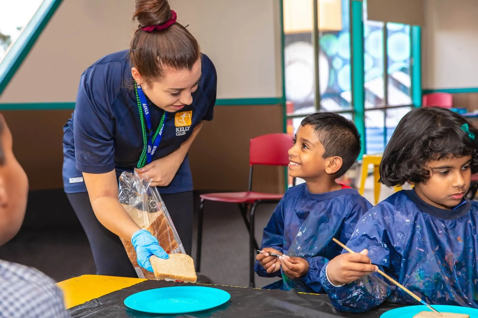 Kelly Club staff helping students make sandwiches