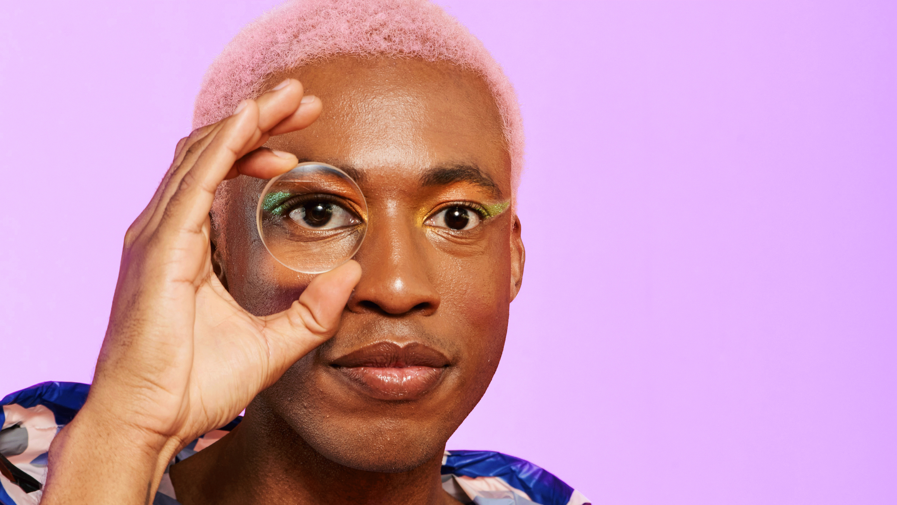 A person looking through a small magnifying glass, used to abstractly represent LLM evaluation and LLM leaderboards.